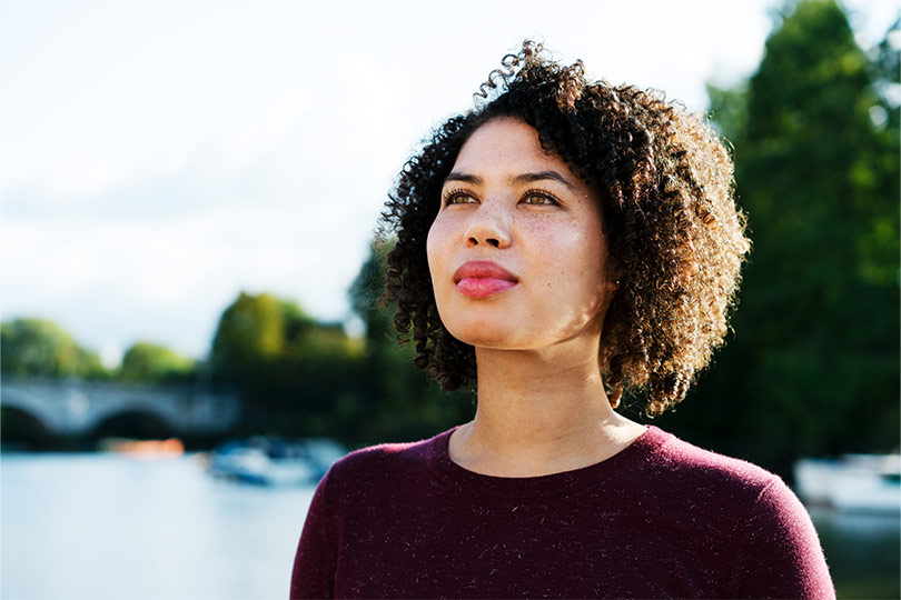 Woman standing outside and thinking about common thyroid myths.