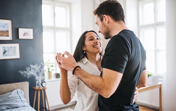 A couple dancing in a room discussing blood pregnancy testing.