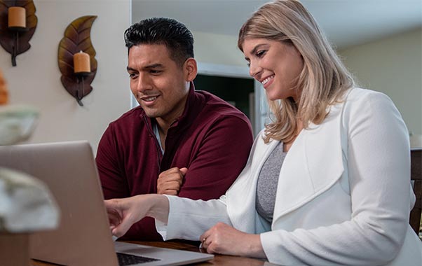 A couple looking at a computer researching male fertility testing.