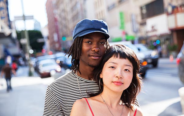 Two people standing next to each other on a street talking about fertility testing.