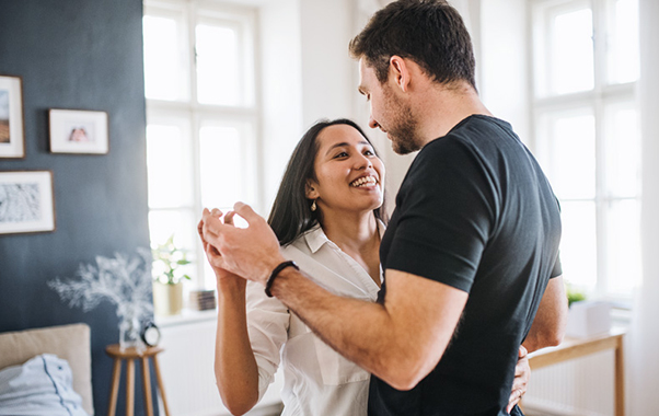 A man and woman hapily dancing