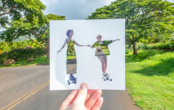 Women skateboarding image superimposed over street.