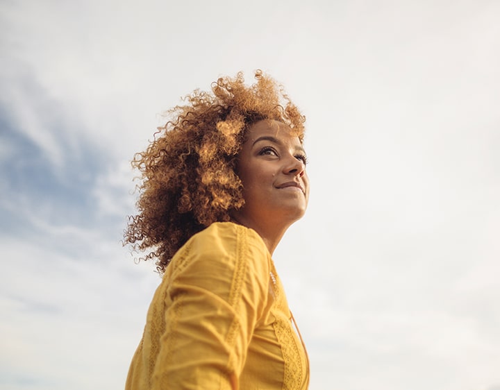 A female looking up at the sky thinking about her AMH hormone level.