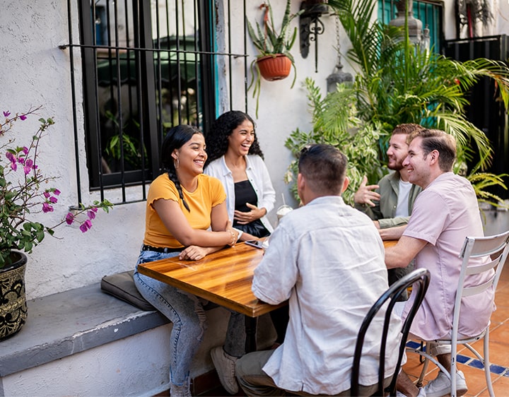 A group of people sitting at a table discussing their hormone health.