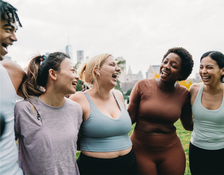 Group of people having a good time outdoors, laughing together in a park setting