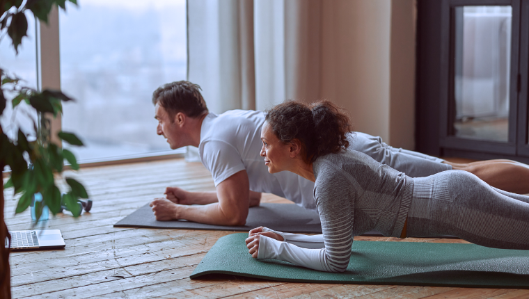 Man and woman do yoga.